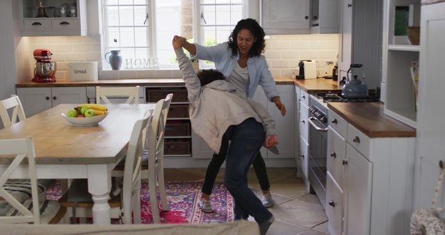 Mother and Son Dancing Together in Cozy Kitchen - Download Free Stock Images Pikwizard.com