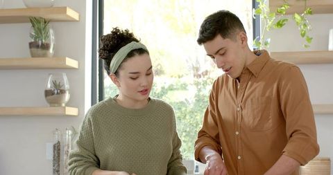 Couple enjoying cooking together with bright natural light