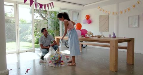 Family collaborating on party cleanup home environment