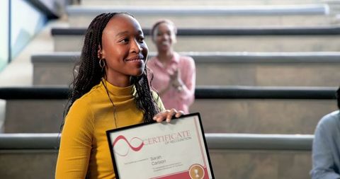 Accomplished woman receives certificate in lecture hall celebration