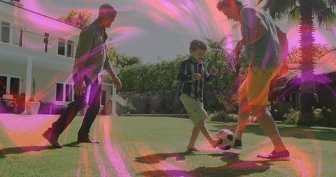 Family Playing Soccer on Lawn with Vibrant Color Effect