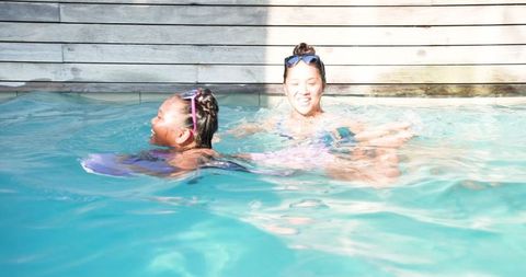 Mother and Daughter Bonding in Relaxing Outdoor Pool Time Activity