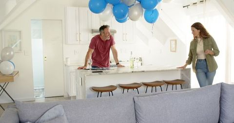 Couple Enjoying Wine and Conversation in Kitchen Celebration