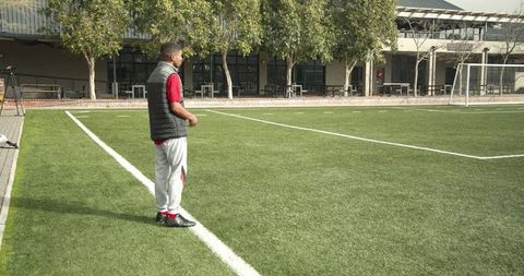 Soccer Coach Observing Players During Training Session on Field - Download Free Stock Images Pikwizard.com