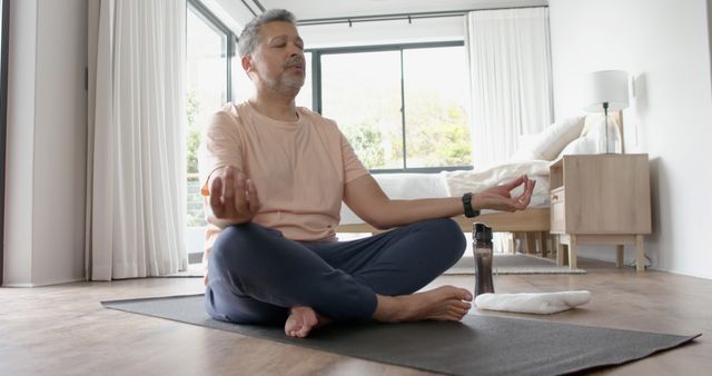 Middle-Aged Man Practicing Meditation on Yoga Mat at Home - Download Free Stock Images Pikwizard.com