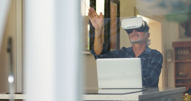 Senior Man Using Virtual Reality Headset with Laptop at Home - Download Free Stock Images Pikwizard.com