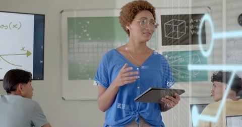 Teacher teaching with tablet using augmented reality math graphics in modern classroom