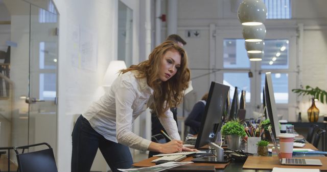 Determined Businesswoman Working at Modern Office Desk - Download Free Stock Images Pikwizard.com