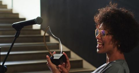 Confident woman presenting at corporate event with award