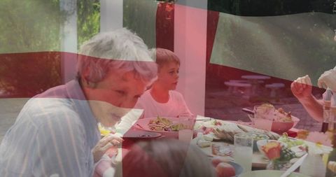 Intergenerational Family Enjoying Outdoor Meal in Natural Setting