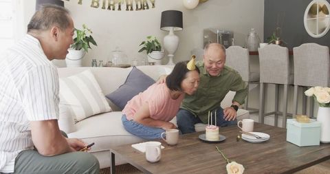 Senior Couple Celebrating Birthday with Cake at Home
