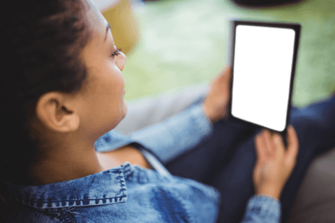 woman in denim holding transparent tablet in park setting - Download Free Stock Videos Pikwizard.com