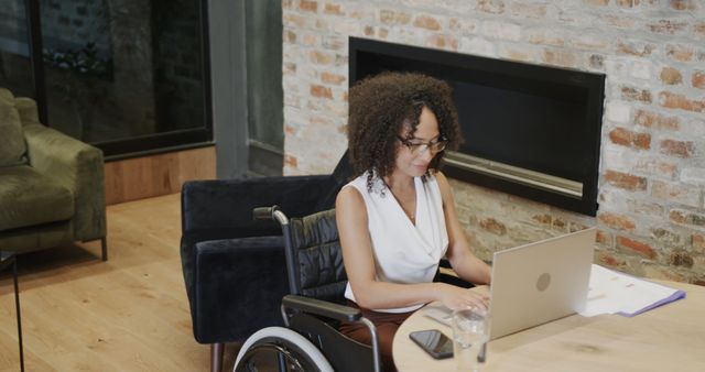 Confident Businesswoman in Wheelchair Working on Laptop in Modern Office - Download Free Stock Images Pikwizard.com