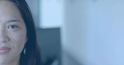 Confident woman gazing forward in modern office space