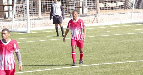 Youth soccer players walking on field showing sportsmanship