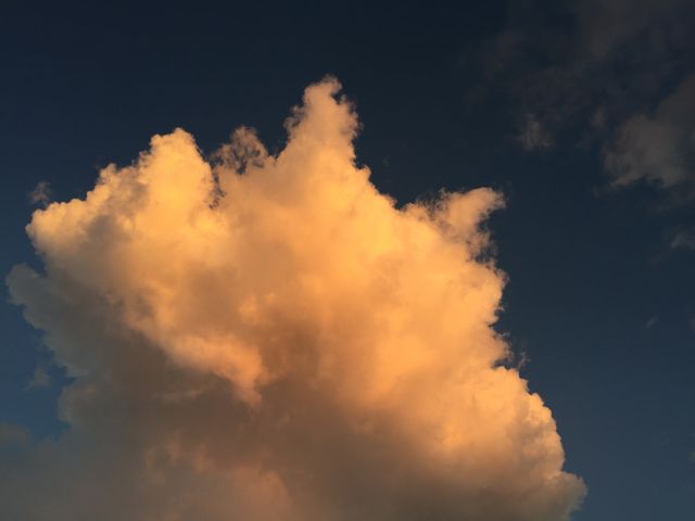 Golden Sunlit Cloud Against Dark Sky During Sunset - Download Free Stock Photos Pikwizard.com