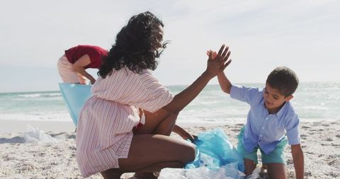 Happy family volunteering for beach cleanup outdoors