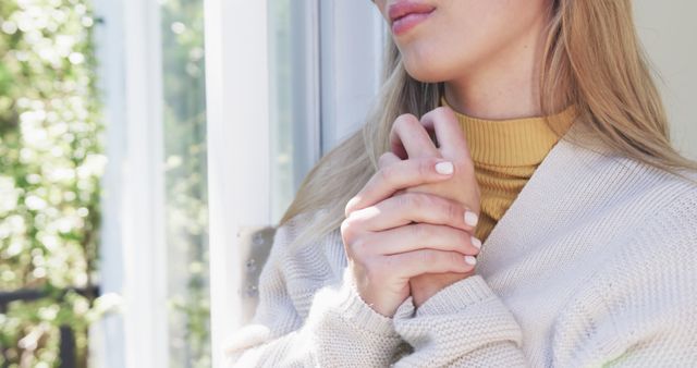 Contemplative Woman Looking Out Window in Cozy Sweater - Download Free Stock Images Pikwizard.com