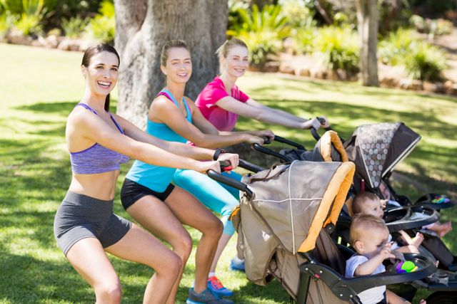 Women exercising with baby stroller in park