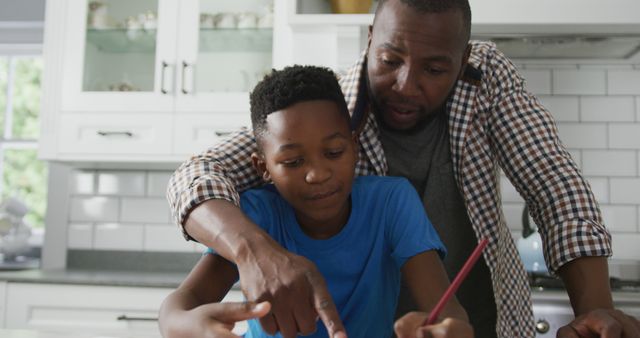 African American dad assists his son with homework, enjoying family time at home. - Download Free Stock Photos Pikwizard.com