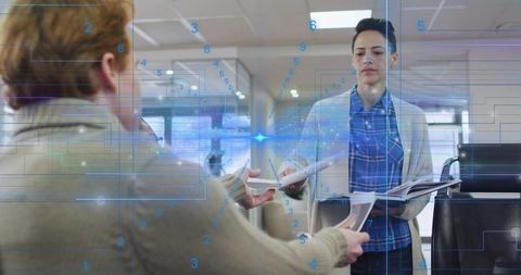 Handing documents while colleague receiving with holographic digital interface overlay