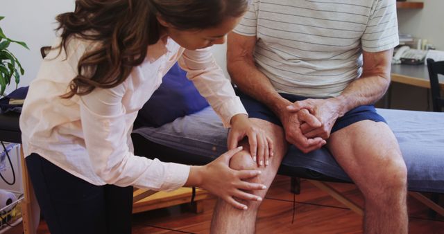 A physiotherapist assesses an elderly man's knee in a clinical environment. - Download Free Stock Photos Pikwizard.com
