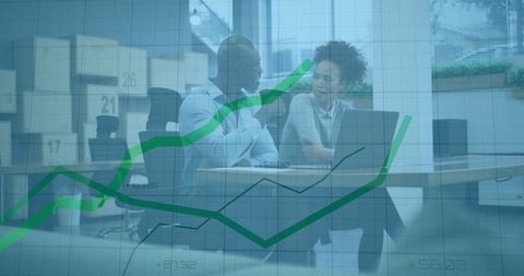 Colleagues Analyzing Data Trends in Modern Office Setting