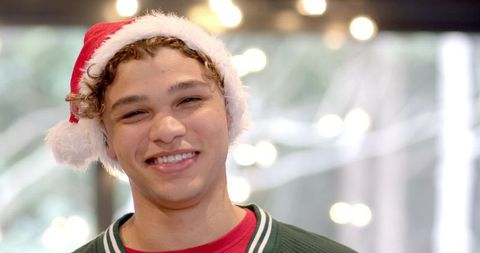 Smiling male with santa hat in festive decor setting