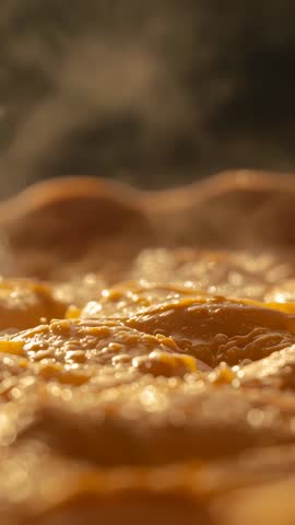 Vertical video of sizzling eggs frying in hot skillet with rising steam for breakfast content