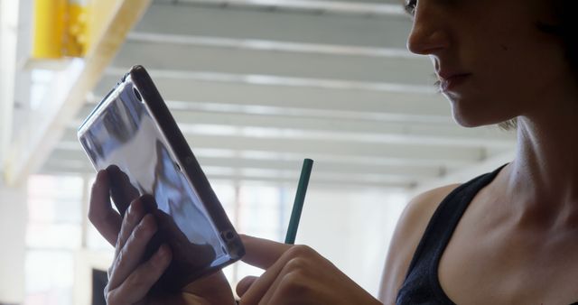 Focused Woman Using Tablet with Stylus in Modern Loft - Download Free Stock Images Pikwizard.com