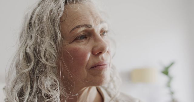 Pensive Elderly Woman with Gray Hair Looking Away - Download Free Stock Images Pikwizard.com