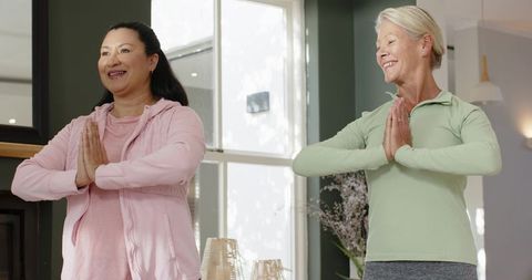 Diverse Women Practicing Yoga in Living Room
