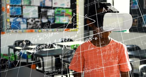 Schoolboy experiencing virtual reality with digital graphs