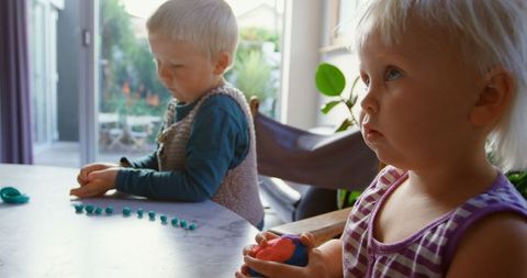 Children Engaged in Creative Play with Colorful Clay Indoors