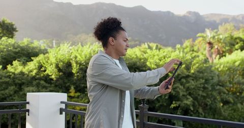 Man enjoying scenic mountain view on balcony in tranquil setting
