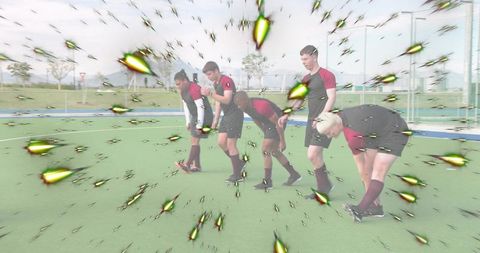 Male team stretching on artificial turf with green starburst overlays and cleats