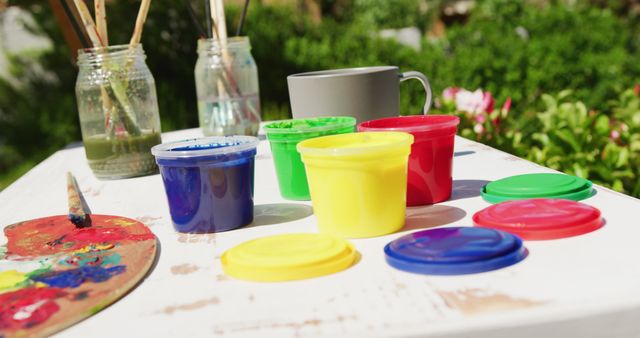 Colorful Paint Containers on Outdoor Table for Art Activities - Download Free Stock Images Pikwizard.com