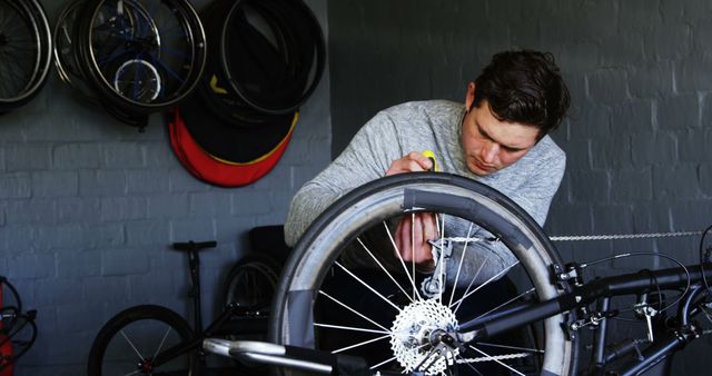 Young Man Repairing Bicycle Tire in Workshop - Download Free Stock Images Pikwizard.com