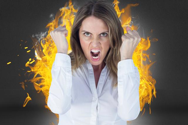 Use this digital composite of an angry businesswoman with clenched fists against a fiery background in scenarios depicting intense emotions, stress in corporate settings, or focused determination. Ideal for illustrating concepts related to frustration, emotional outbursts, workplace challenges, or powerful reactions.
