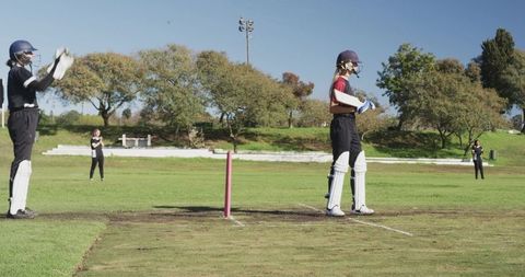Female Cricket Players on Field Preparing for Match