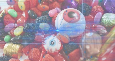 Novelty Eyeball Candies Sitting Among Colorful Gummies and Chocolates with Digital Grid Overlay