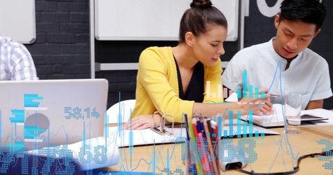 Collaborative team working with financial data projections