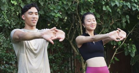 Diverse Friends Stretching Together in Backyard Garden Doing Outdoor Fitness Warmup