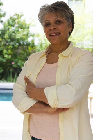 Senior Woman Smiling Confidently Outdoors on a Sunny Day