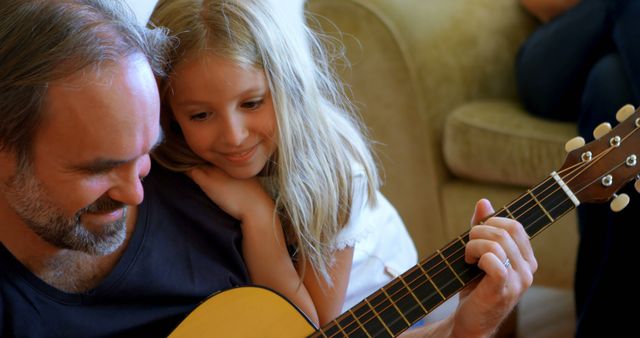Father and Daughter Bonding While Learning Guitar at Home - Download Free Stock Images Pikwizard.com