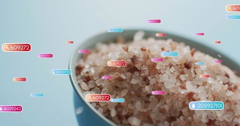 Social media notifications floating over ceramic bowl of coarse pink himalayan salt