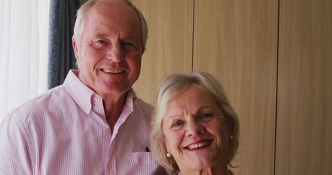 Elderly Couple Smiling at Home in Warm Ambiance