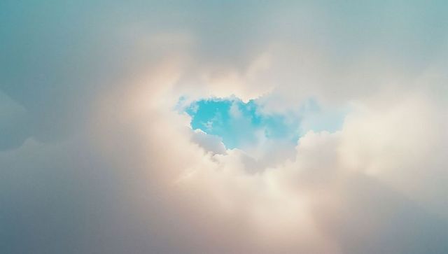 Ethereal cloudscape with central blue sky opening