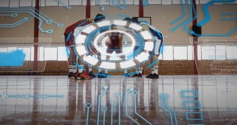 Huddling basketball team forming digital strategy circle on indoor court with blue hud