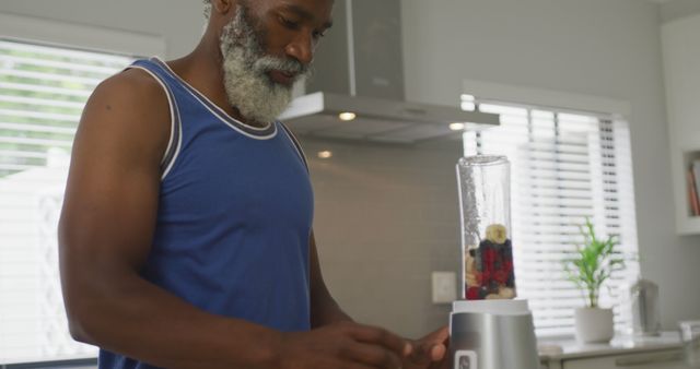 Image of african american senior man preparing smoothie - Download Free Stock Photos Pikwizard.com